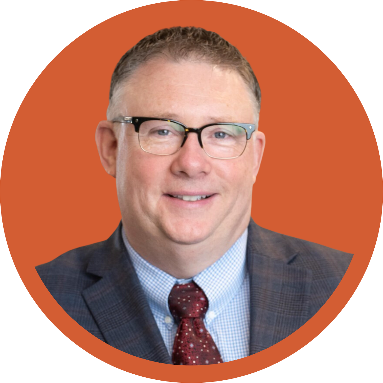 Man with glasses in orange circle.