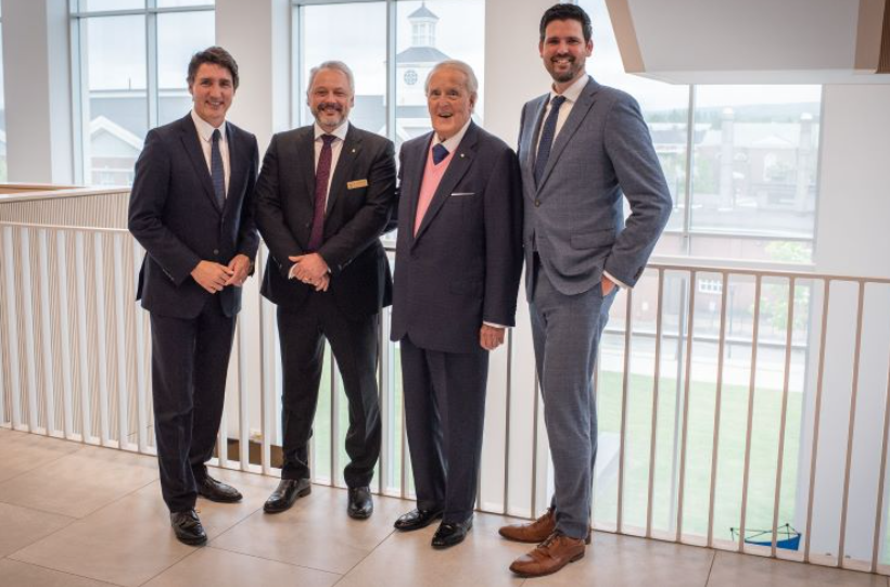 Group of people wearing suites in Mulroney Hall
