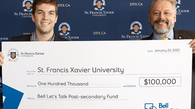 StFX's representative receiving 100,000 dollars prize from Bell's representative
