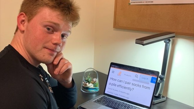Student sitting at desk with computer 