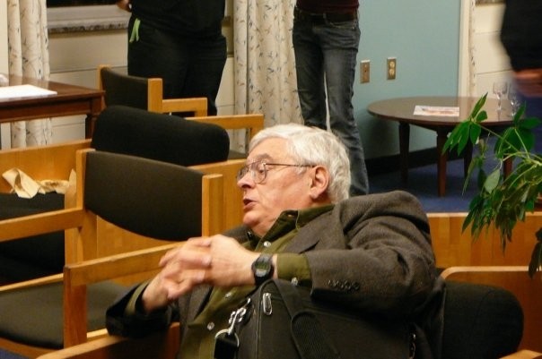 Close up of a man sitting on a chair in lounge area.