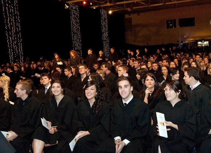 Large group of people wearing black gowns
