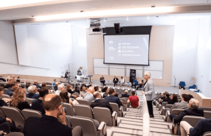 People sitting in Mulroney Hall auditorium