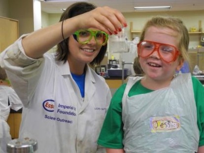 A woman and a girl wearing goggles in a lab